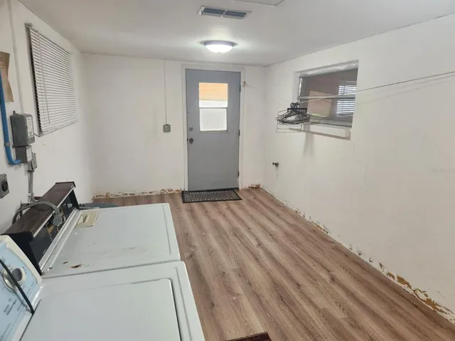 a view of a storage & utility room with a sink