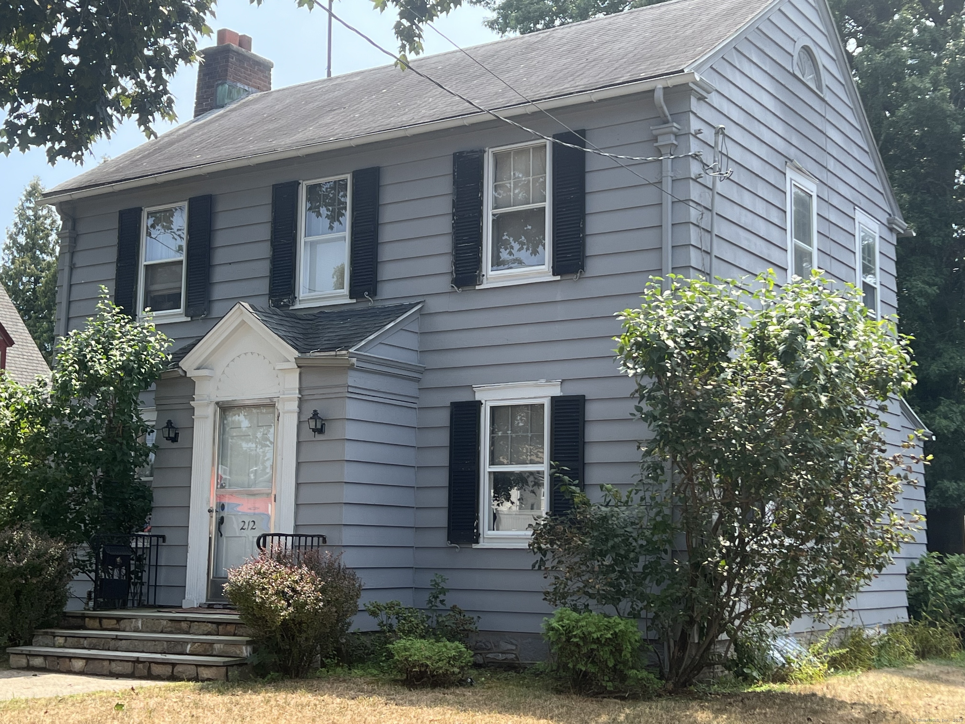 Undisclosed Address Bridgeport, CT 06610 - Photo 1 of 1 a front view of a house with garden