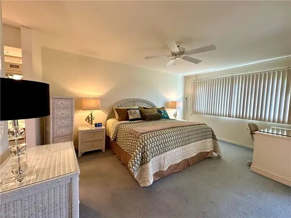 a bedroom with a bed and a television