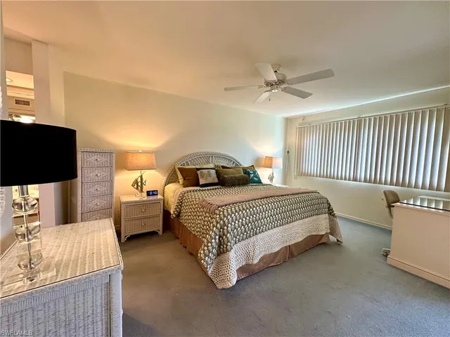 a bedroom with a bed and a television