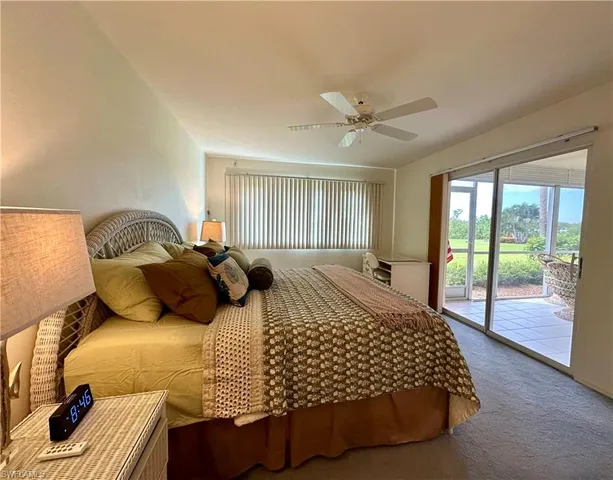 a bedroom with a large bed and a large window
