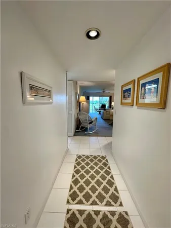 a hallway with a couch and a window