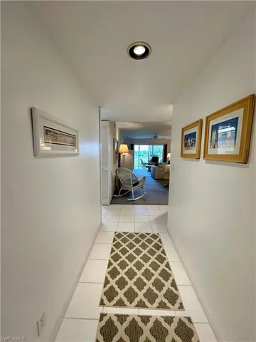 a hallway with a couch and a window