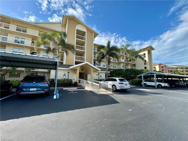 a view of a cars park in front of a building