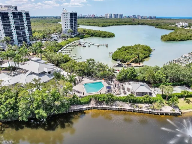 an aerial view of a house with a garden and lake view