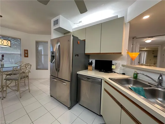 a kitchen with a sink cabinets and stainless steel appliances