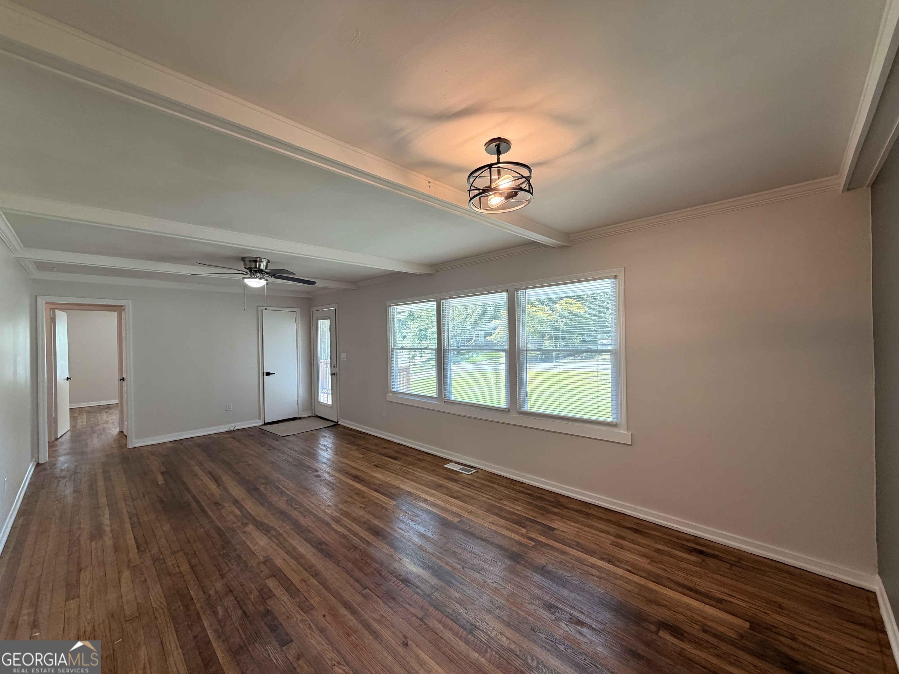 1734 Cahoon Street Southwest Atlanta, GA 30310 - Photo 12 of 29 a view of an empty room with a window and wooden floor