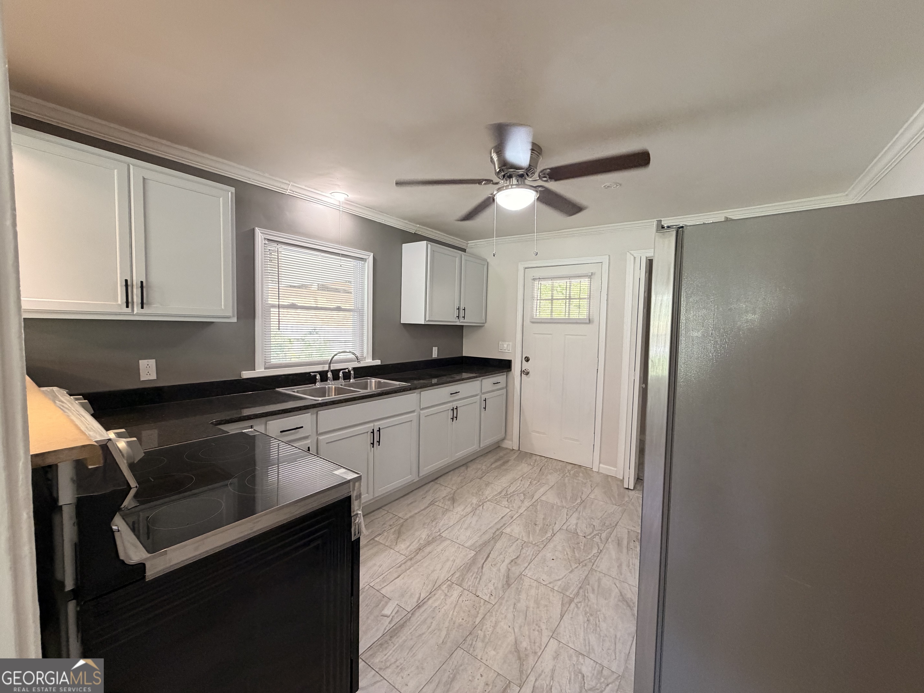 1734 Cahoon Street Southwest Atlanta, GA 30310 - Photo 13 of 29 a kitchen with a refrigerator a sink and cabinets