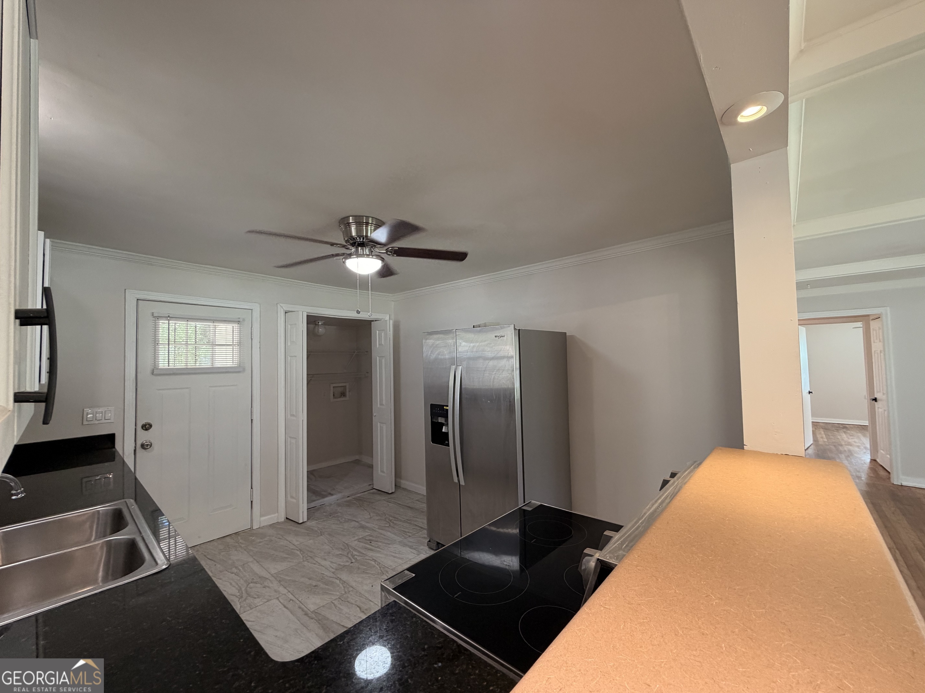 1734 Cahoon Street Southwest Atlanta, GA 30310 - Photo 14 of 29 a bedroom with a bed and a chandelier