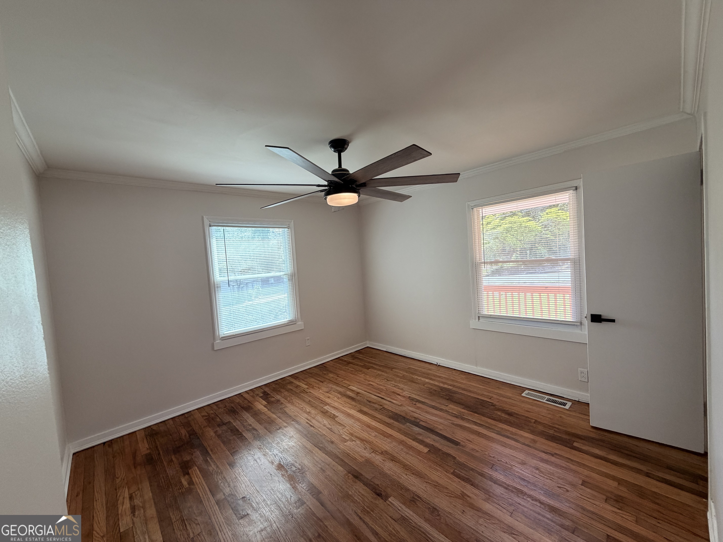 1734 Cahoon Street Southwest Atlanta, GA 30310 - Photo 17 of 29 a view of empty room with wooden floor and fan