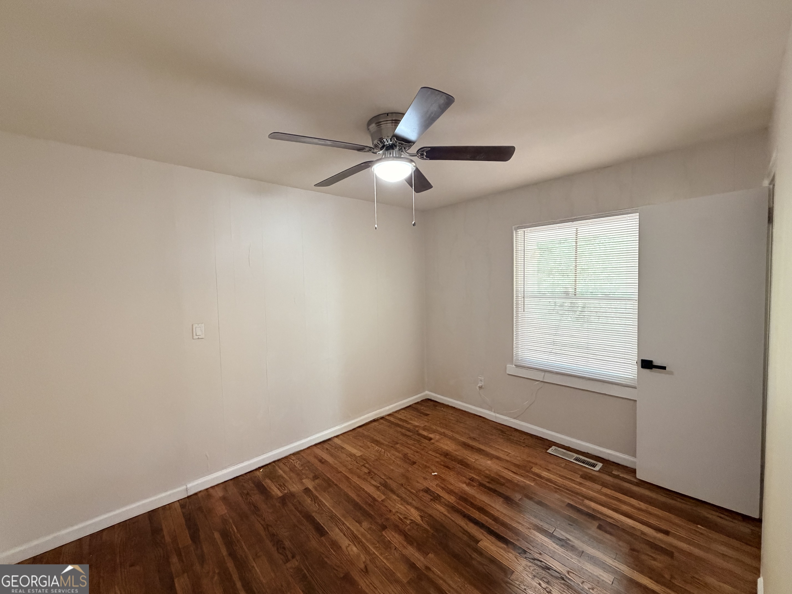 1734 Cahoon Street Southwest Atlanta, GA 30310 - Photo 23 of 29 a view of empty room with wooden floor and fan