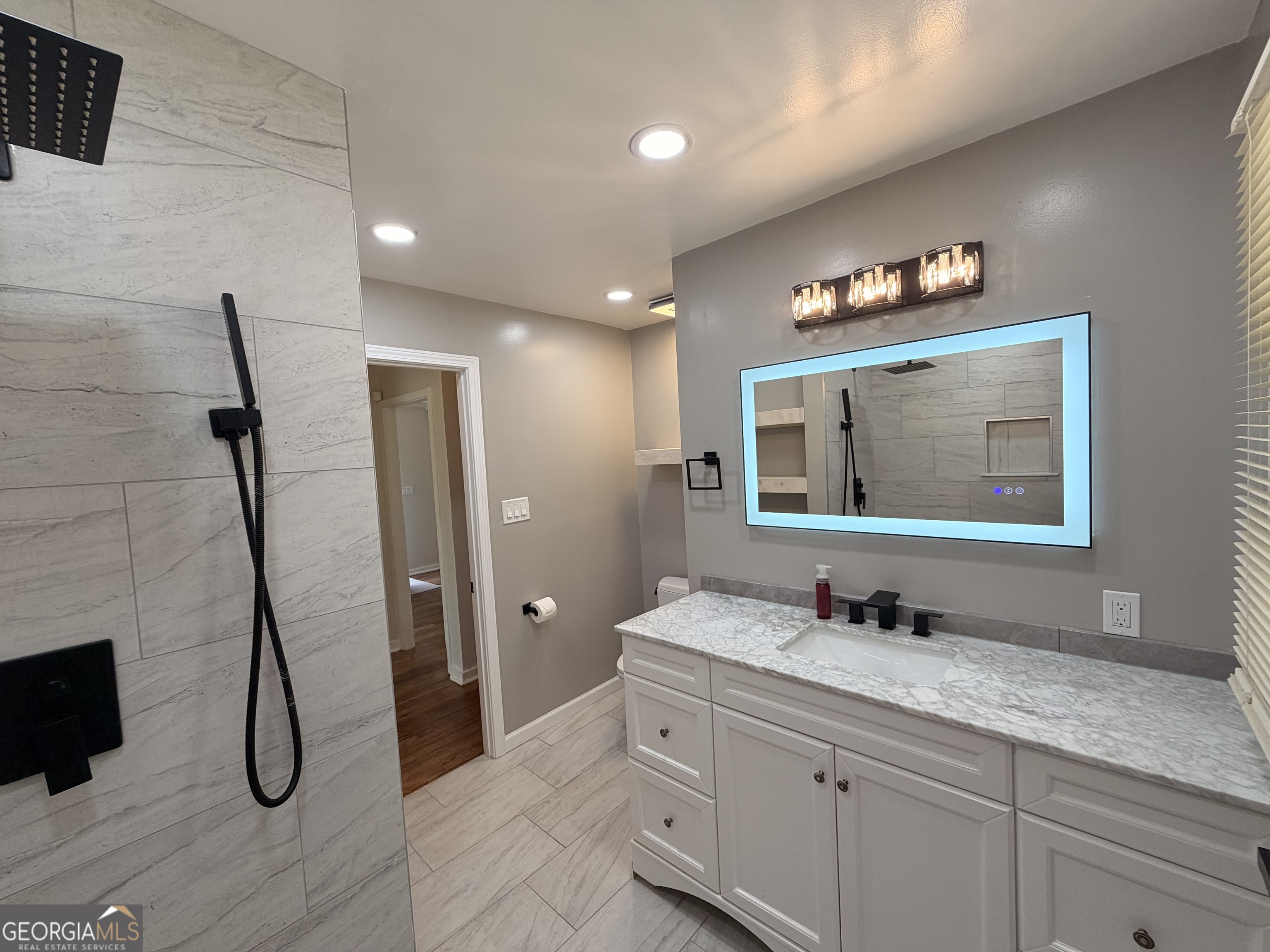 1734 Cahoon Street Southwest Atlanta, GA 30310 - Photo 29 of 29 a bathroom with a granite countertop sink mirror and shower