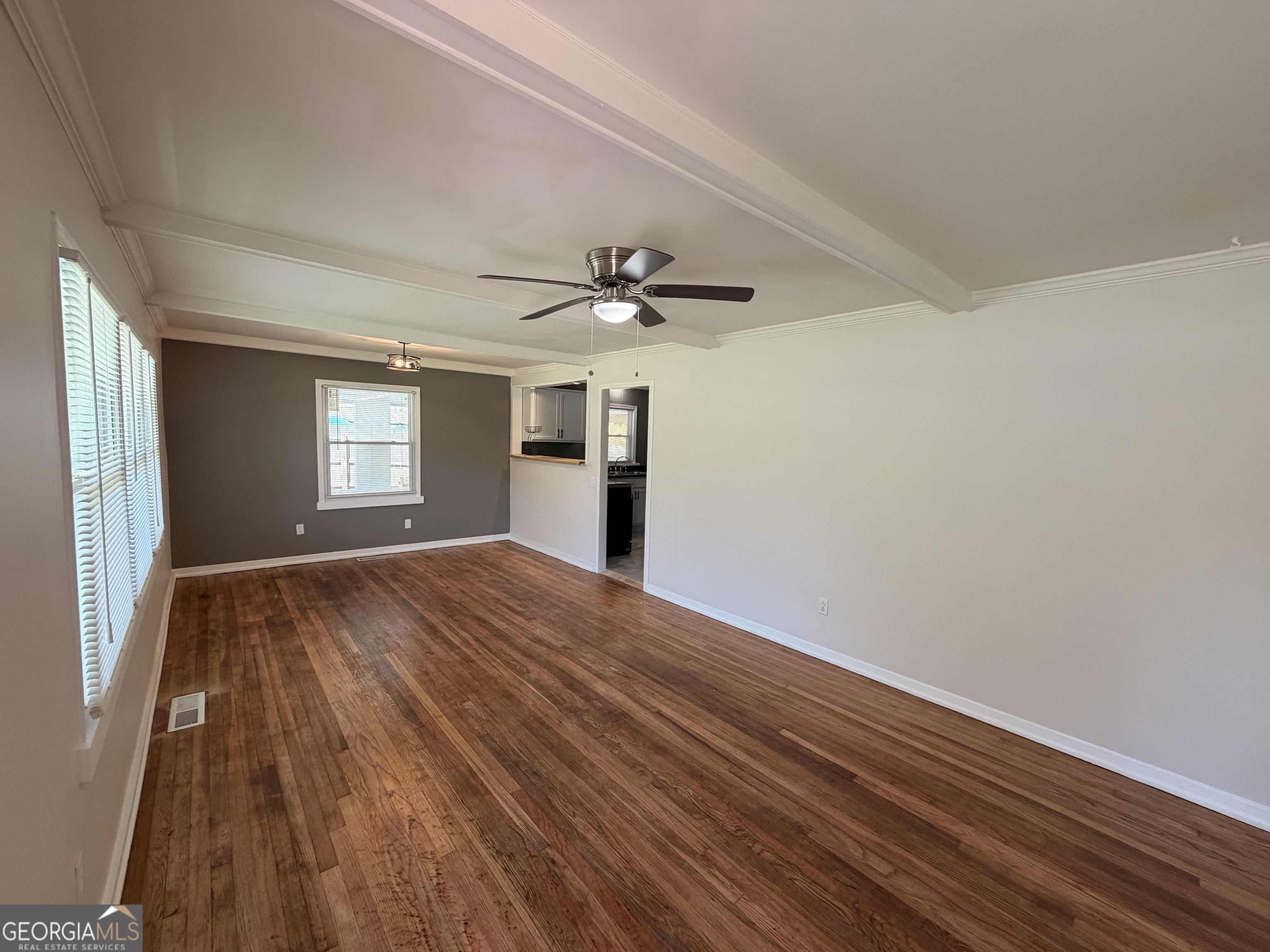 1734 Cahoon Street Southwest Atlanta, GA 30310 - Photo 9 of 29 a view of empty room with wooden floor and fan