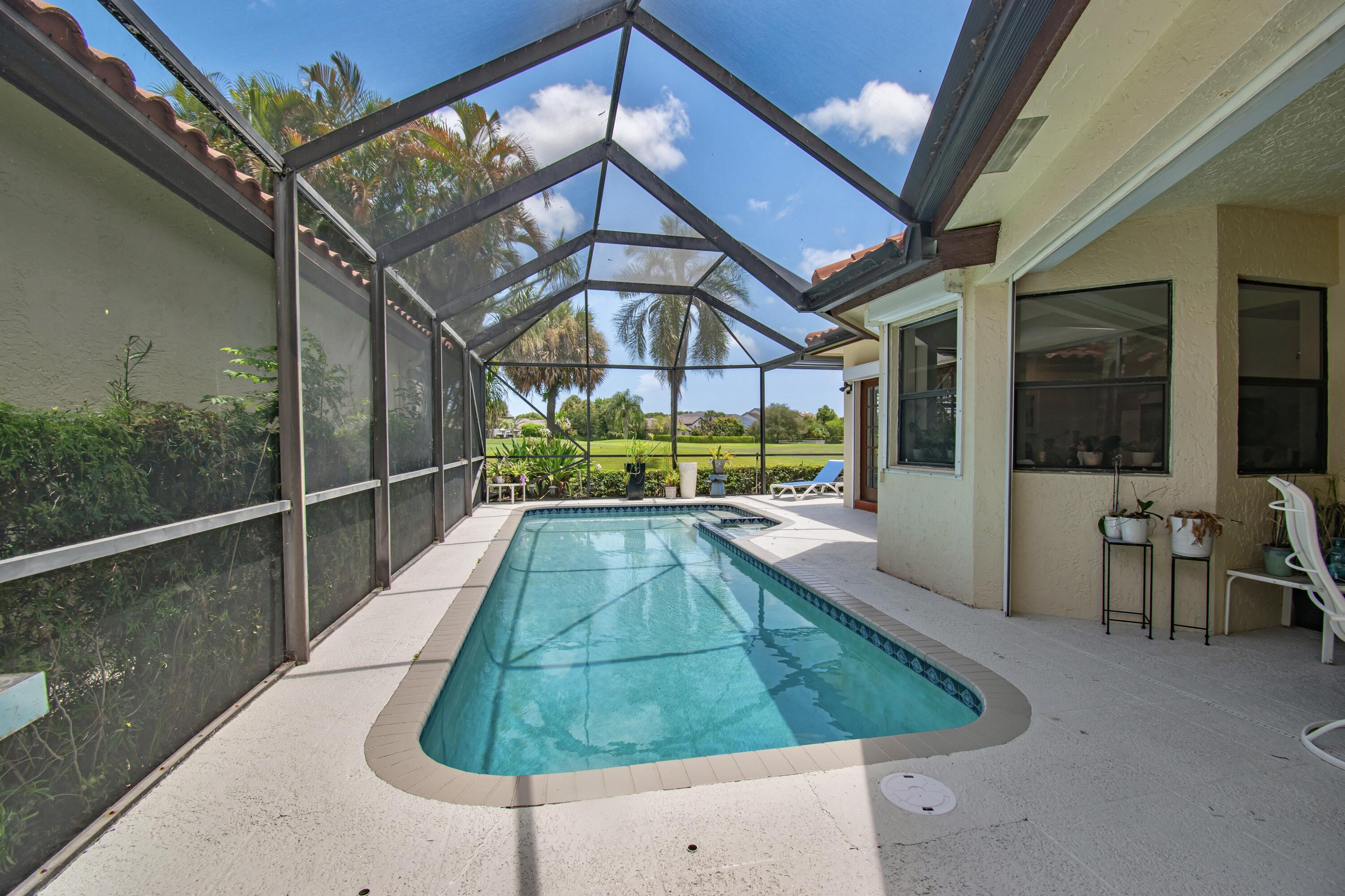 22504 Esplanada Circle Boca Raton, FL 33433 - Photo 39 of 47 a view of a swimming pool with a patio and a yard