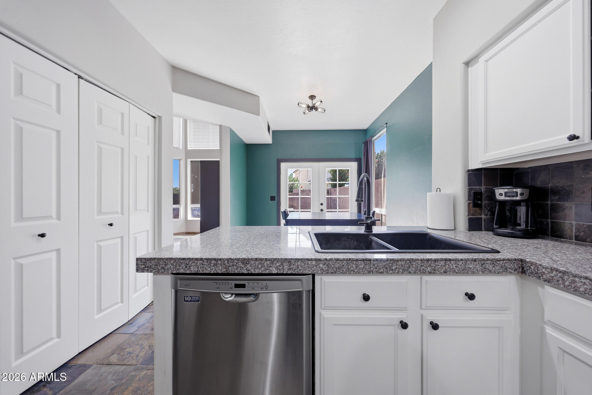 2167 East Nighthawk Way Phoenix, AZ 85048 - Photo 10 of 28 a kitchen with granite countertop a sink and white cabinets