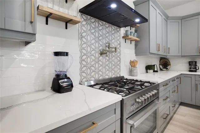 a kitchen with a stove and a white cabinets
