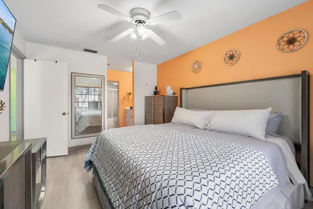 a bedroom with a large bed and a chandelier