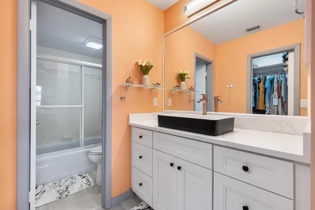 a bathroom with a shower sink and mirror