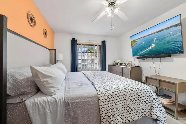 a bedroom with a bed and a flat screen tv