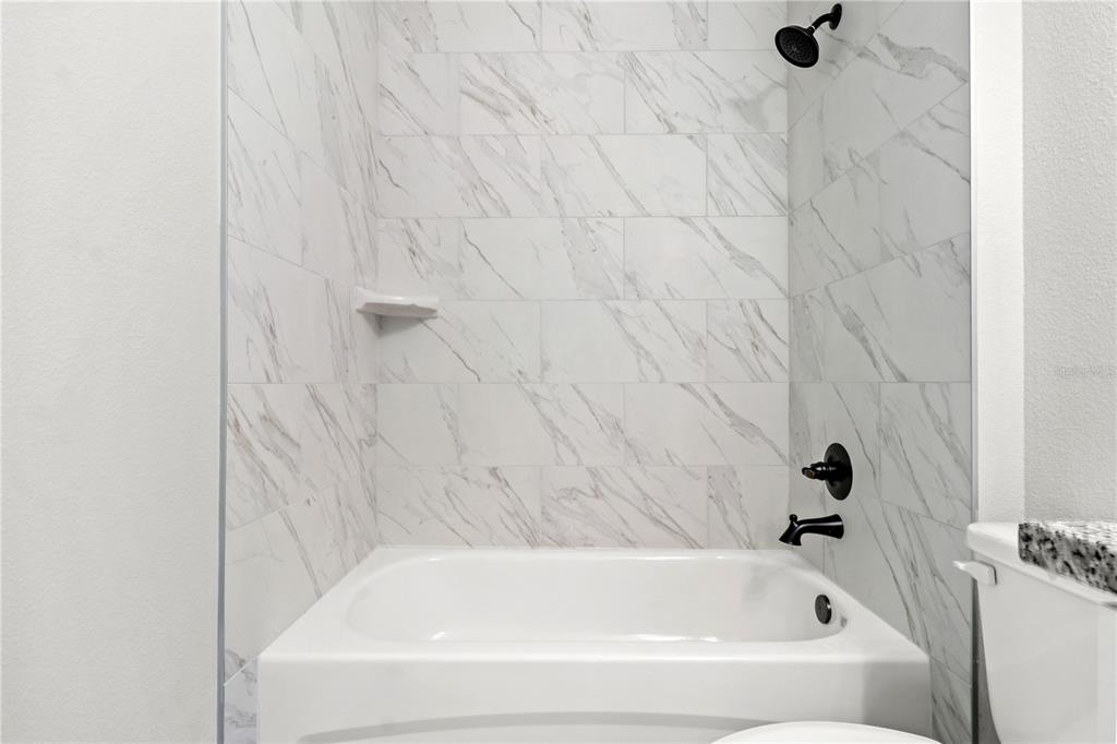 605 Abarth Avenue Sebring, FL 33872 - Photo 12 of 28 a bathroom with a bathtub