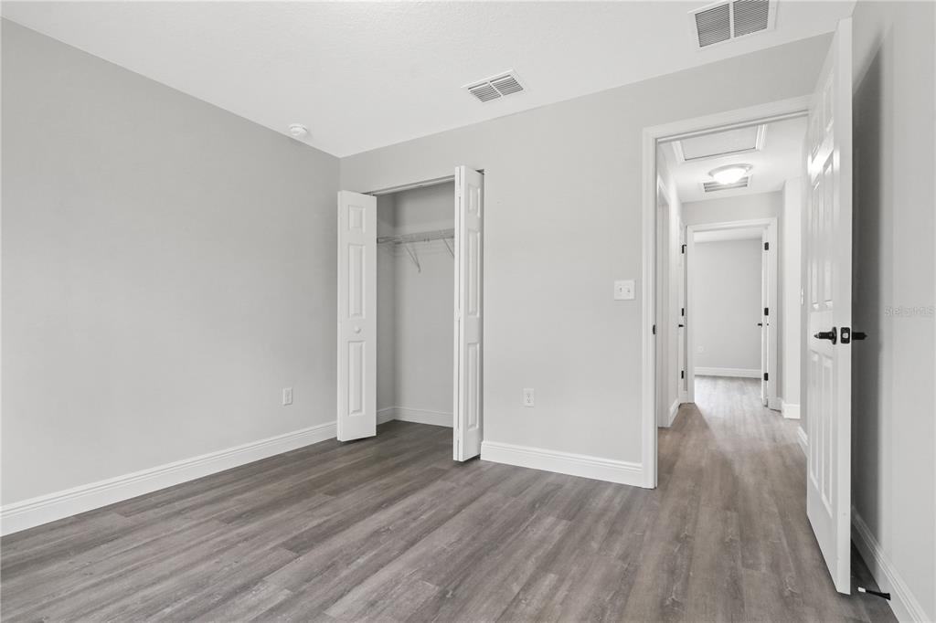 605 Abarth Avenue Sebring, FL 33872 - Photo 14 of 28 a view of a hallway with wooden floor