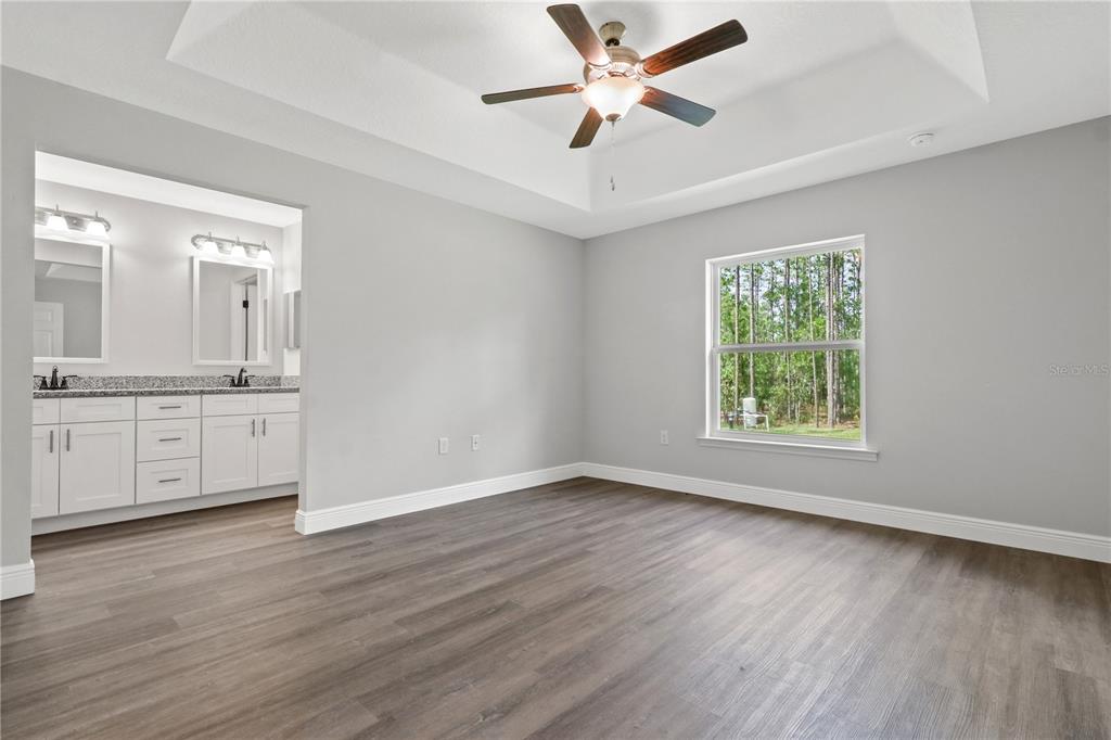 605 Abarth Avenue Sebring, FL 33872 - Photo 15 of 28 an empty room with wooden floor and windows