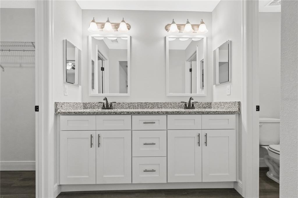 605 Abarth Avenue Sebring, FL 33872 - Photo 17 of 28 a bathroom with double vanity sinks a vanity two mirror and a shower