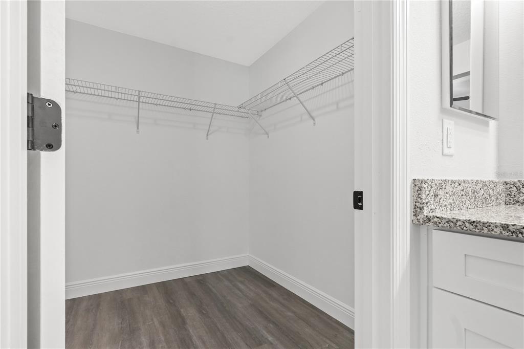 605 Abarth Avenue Sebring, FL 33872 - Photo 18 of 28 a view of a storage and utility room with wooden floor