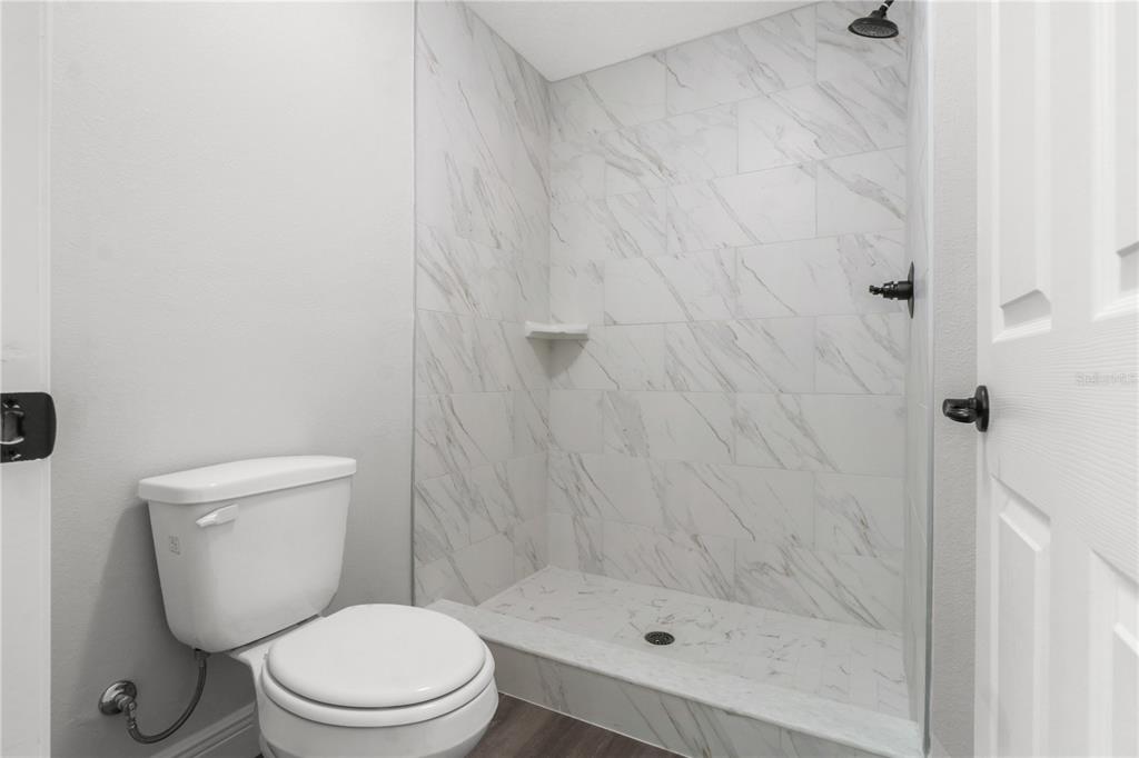 605 Abarth Avenue Sebring, FL 33872 - Photo 19 of 28 a white toilet sitting next to a shower