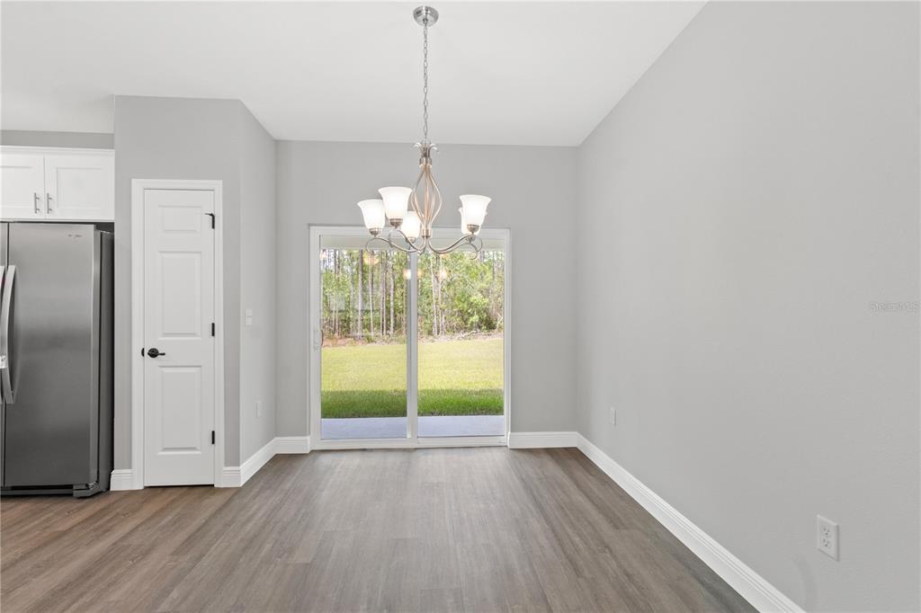 605 Abarth Avenue Sebring, FL 33872 - Photo 8 of 28 wooden floor in an empty room with a window