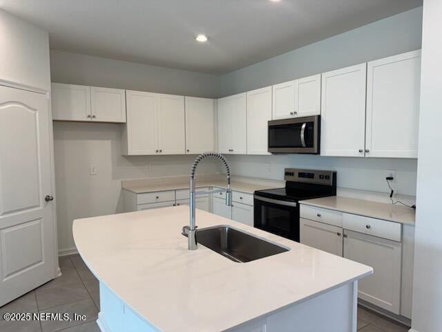 33 Summer Moon Drive St. Augustine, FL 32095 - Photo 2 of 41 a kitchen with a sink a stove top oven and white cabinets