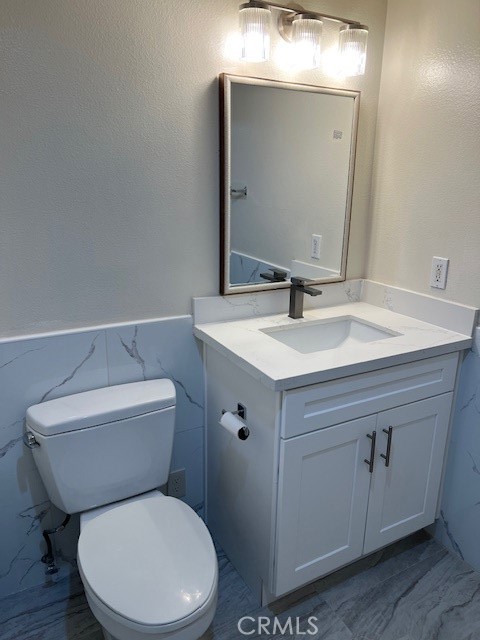 918 West Garvey Avenue, Unit 103 Monterey Park, CA 91754 - Photo 12 of 25 a bathroom with a toilet sink and mirror