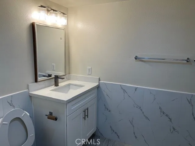 a bathroom with a sink vanity and a mirror