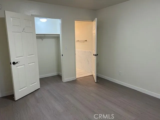 an empty room with wooden floor and closet