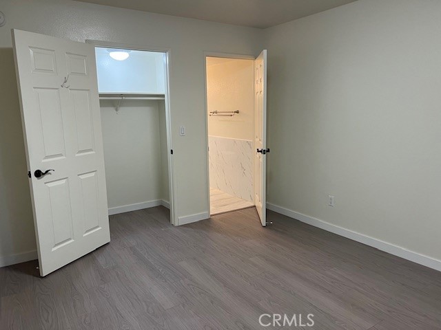 918 West Garvey Avenue, Unit 103 Monterey Park, CA 91754 - Photo 6 of 25 an empty room with wooden floor and closet