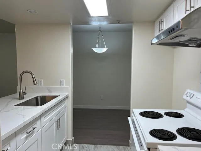 a kitchen with a sink and cabinets