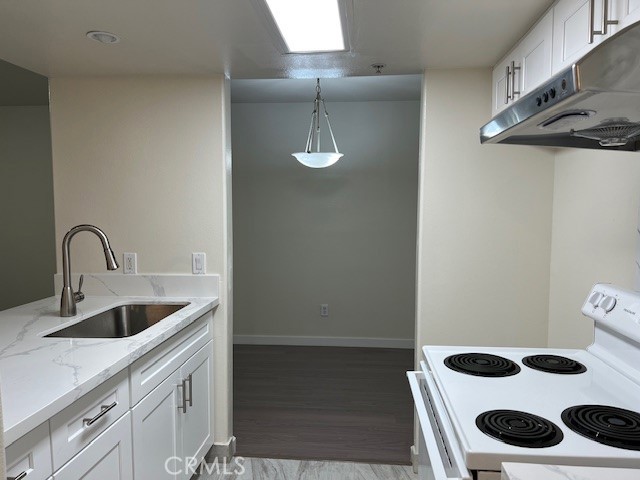918 West Garvey Avenue, Unit 103 Monterey Park, CA 91754 - Photo 8 of 25 a kitchen with a sink and cabinets