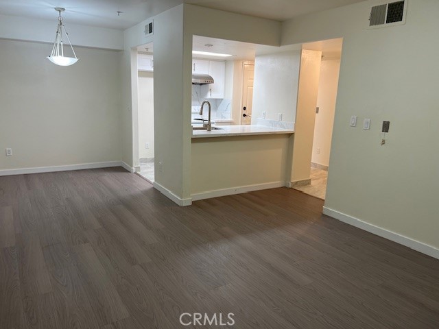 918 West Garvey Avenue, Unit 103 Monterey Park, CA 91754 - Photo 10 of 25 a view of a kitchen with wooden floor and a sink