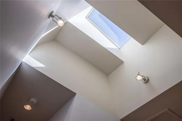 a spacious bathroom with a tub sink and mirror
