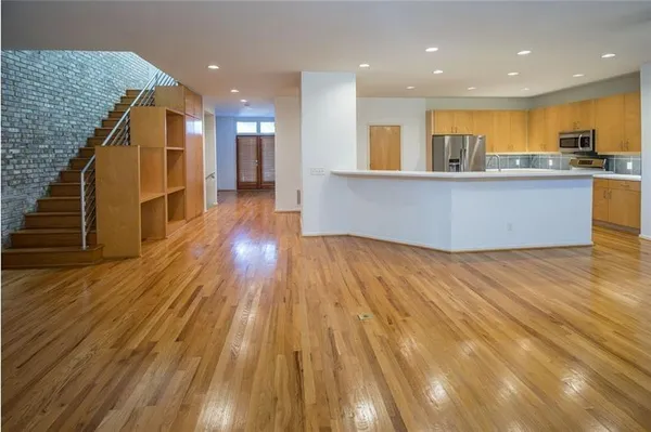 a kitchen with stainless steel appliances granite countertop a refrigerator and a sink