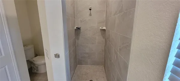 a bathroom with a glass door shower