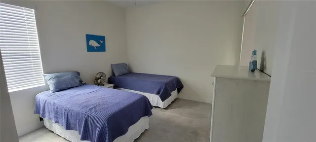 a bedroom with two beds and painted walls