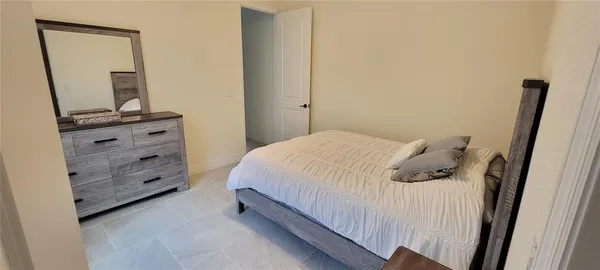 a bed room with a bed and a mirror