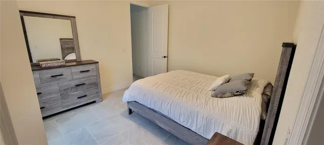 a bed room with a bed and a mirror