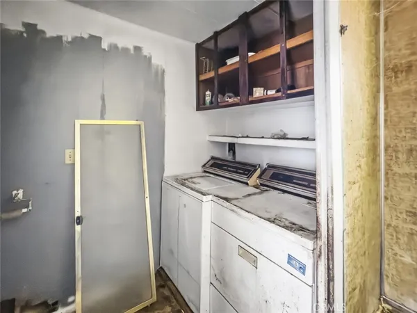a bathroom with a granite countertop sink a mirror and shower