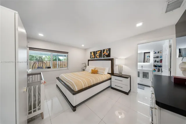 a bed room with a bed and large window