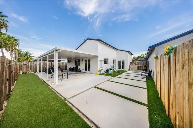 a front view of a house with a yard table and chairs