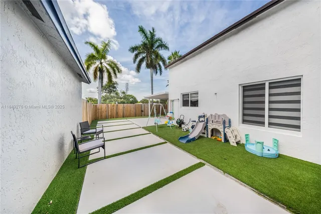a front view of a house with garden and sitting area