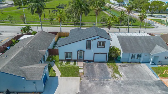 a view of house with a yard and sitting area
