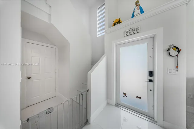 a view of a hallway with entryway door